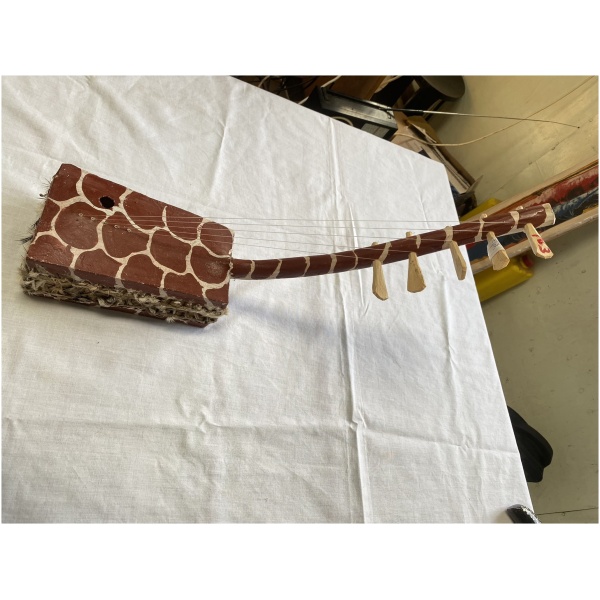 wooden 5 string musical instrument with giraffe pattern