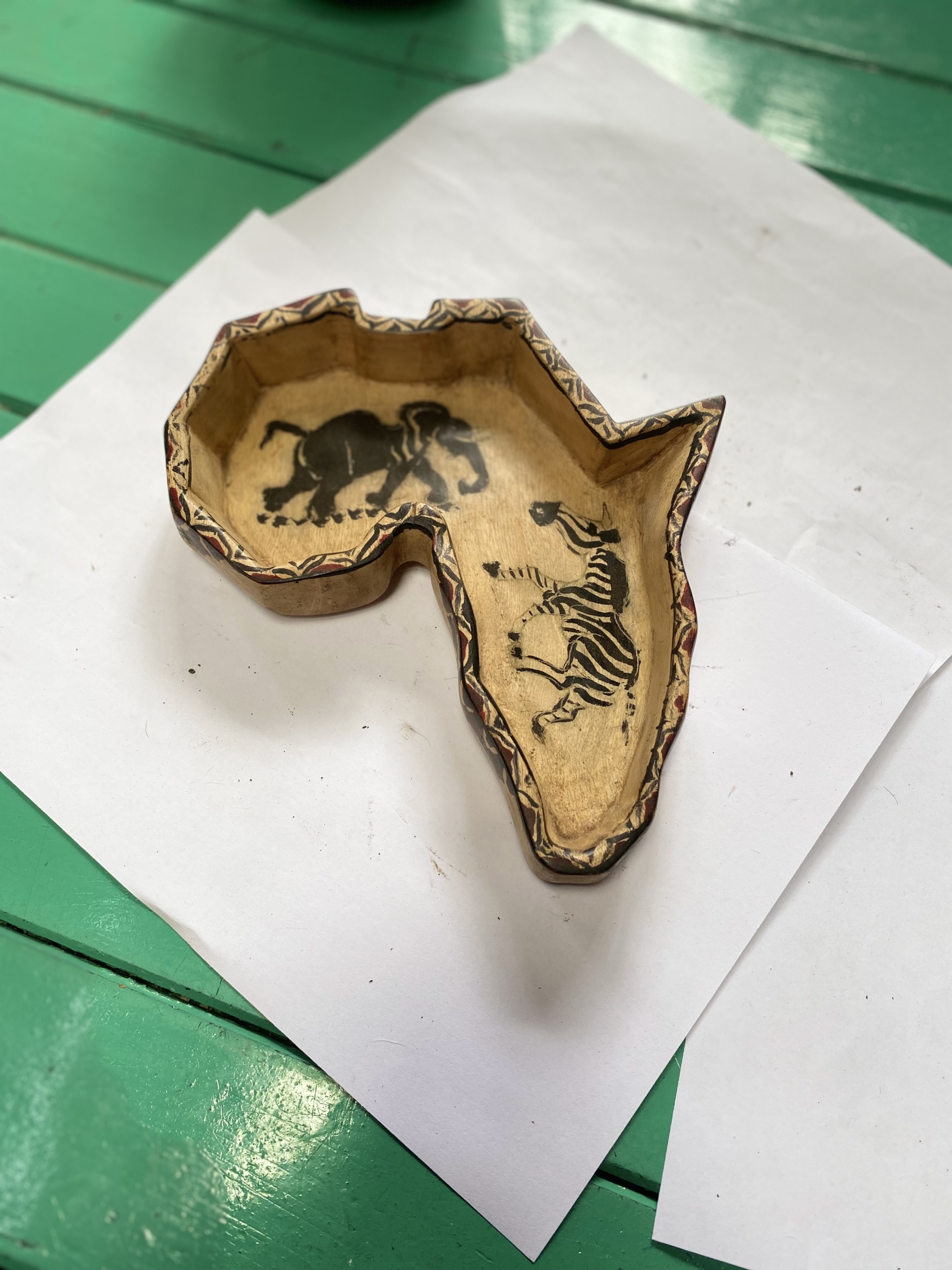 wooden africa shaped bowl with animal drawings