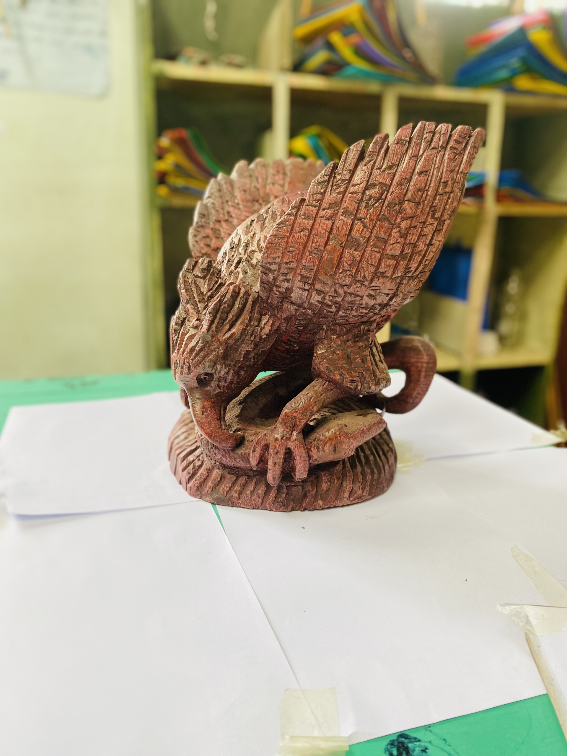 wooden bird praying on snake