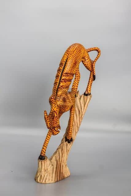 wooden cheetah on tree