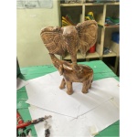 wooden elephant holding big elephant head