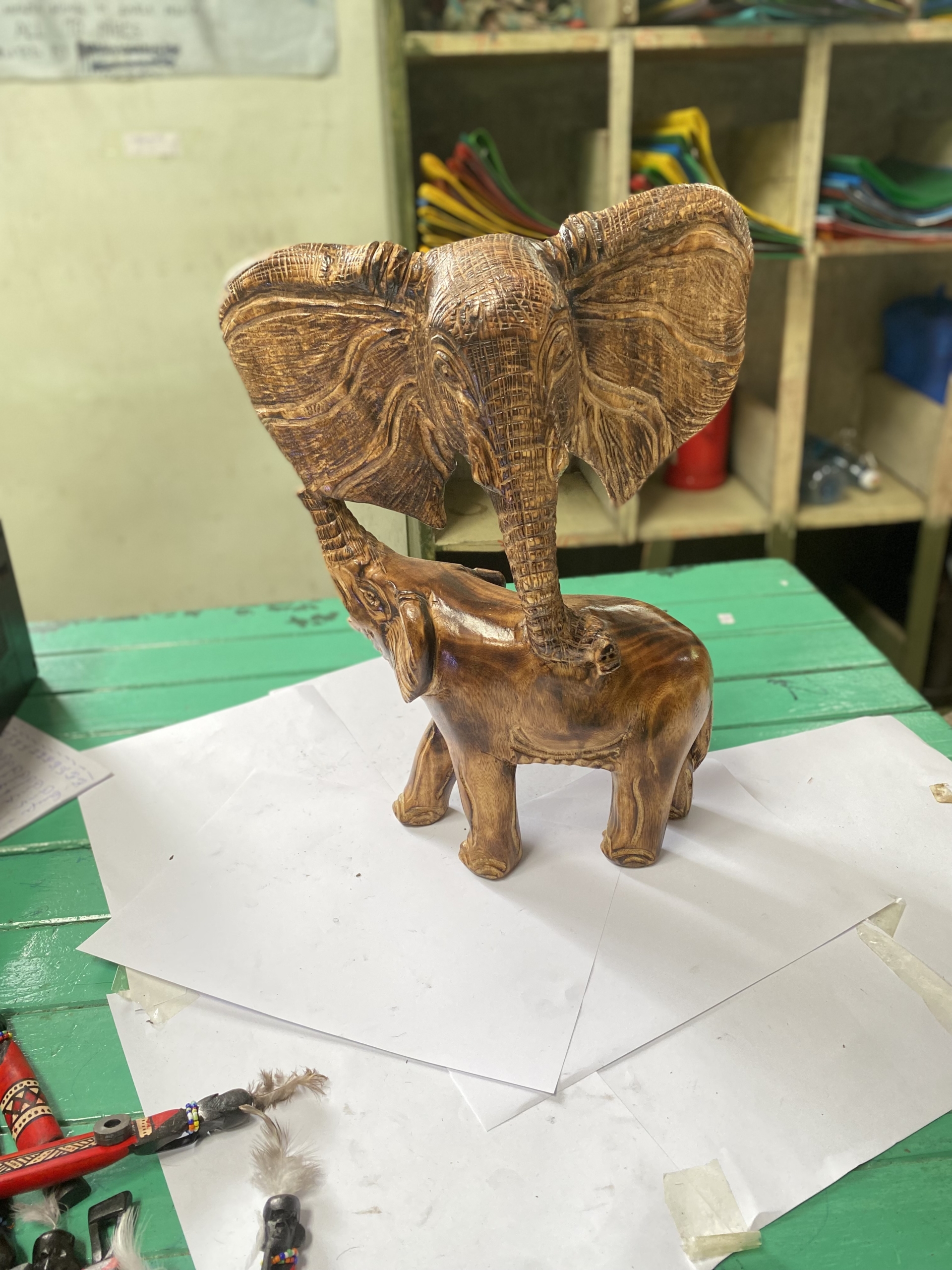 wooden elephant holding big elephant head