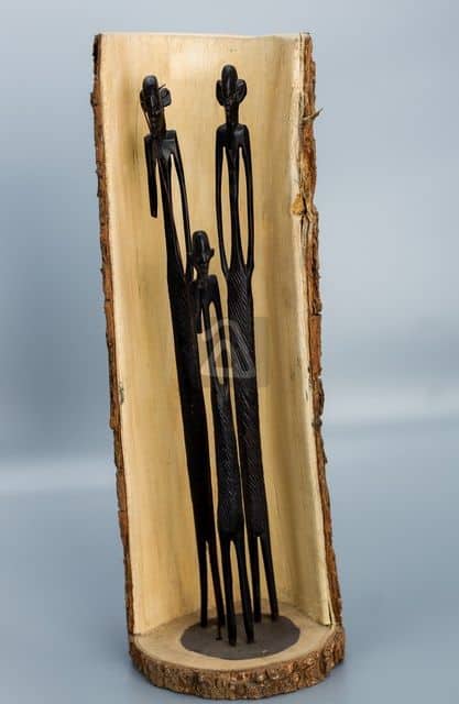 wooden family carved into tree trunk