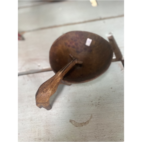 wooden giraffe drinking from bowl