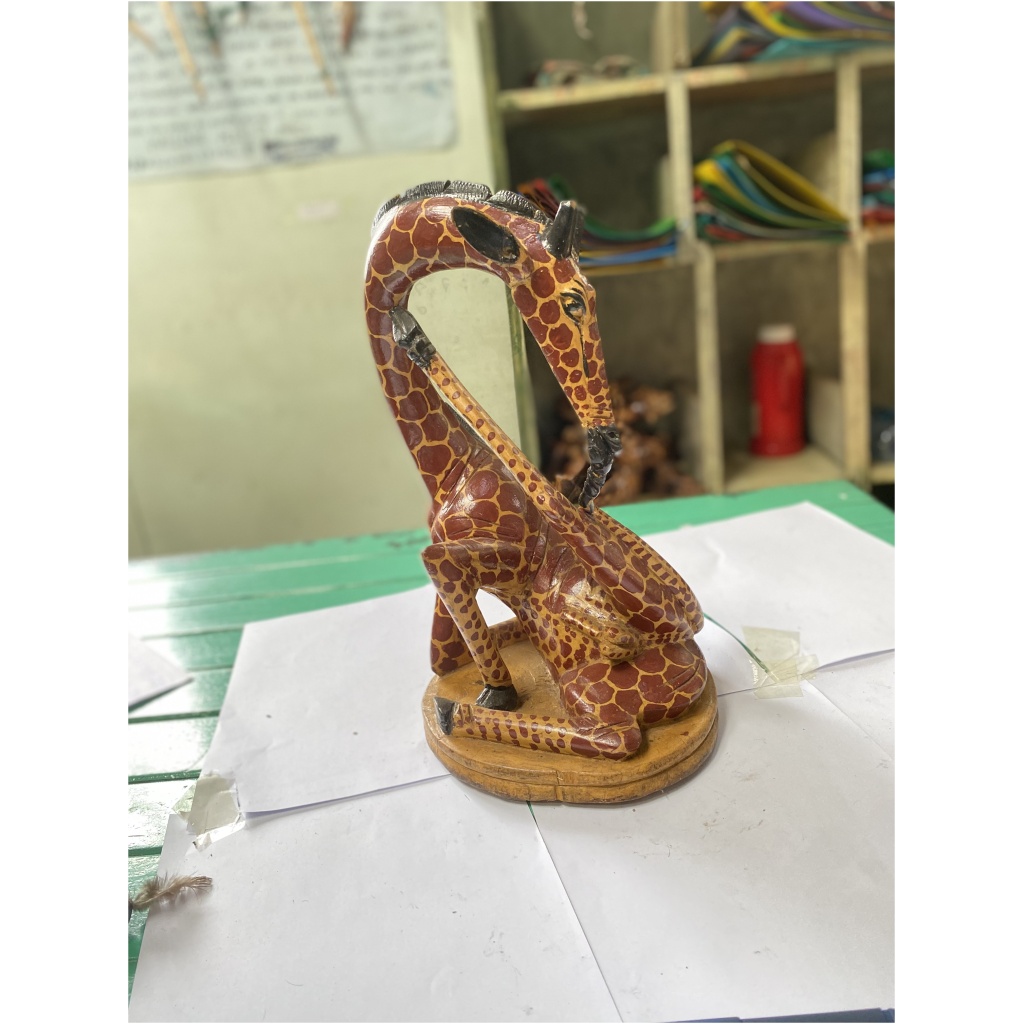 wooden giraffe licking leg