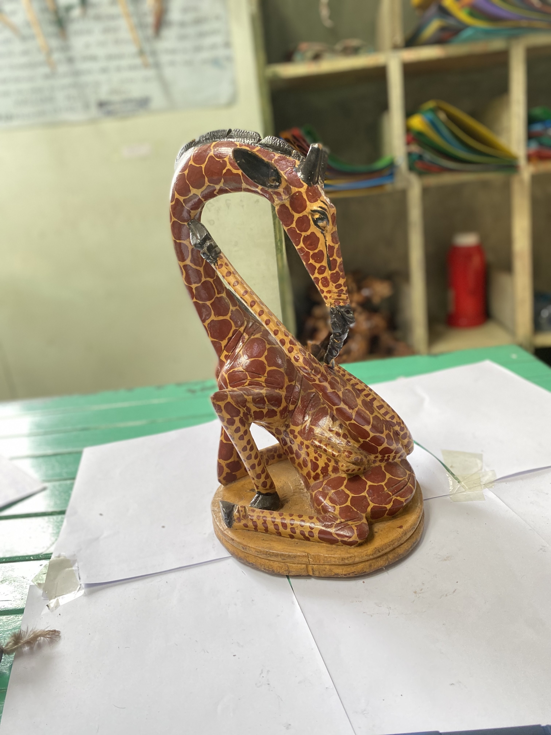 wooden giraffe licking leg