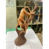 wooden leopard hunting gazelle on tree