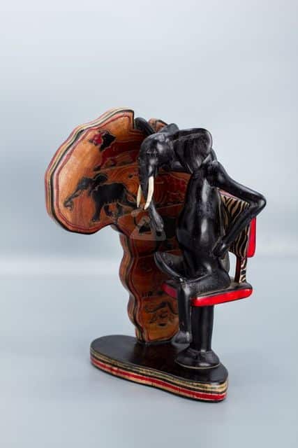 wooden sitting elephant holding map of africa